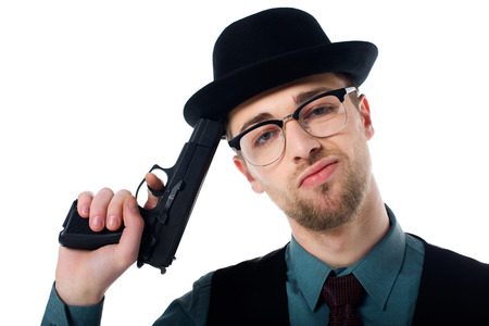 Portrait of spy agent in hat and eyeglasses with gun isolated on white backgroundの写真素材