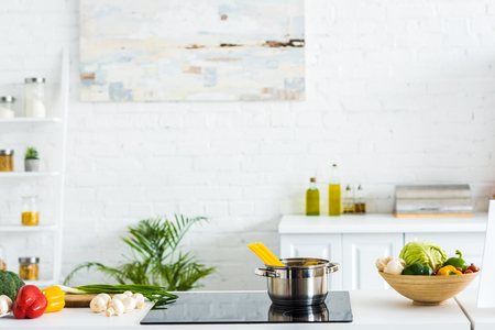 Interior of modern light kitchen with paint on wall and electric stove