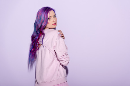 sensual young woman with purple hair on pinkの写真素材