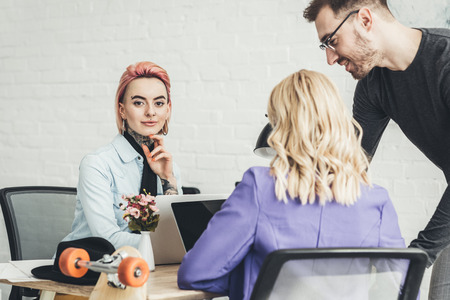 selective focus of young creative workers working on new idea in office