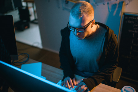 high angle view of hacker developing malware in dark roomの写真素材