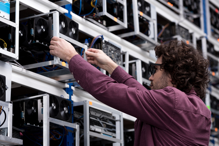 computer engineer taking out box with graphic card at ethereum mining farmの写真素材