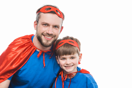 happy super dad and son smiling at camera isolated on whiteの写真素材