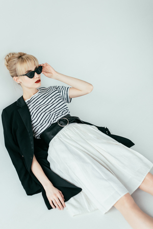 Fashionable blonde girl wearing black and white clothesの写真素材