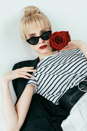 Stylish pretty woman posing with red roseの写真素材