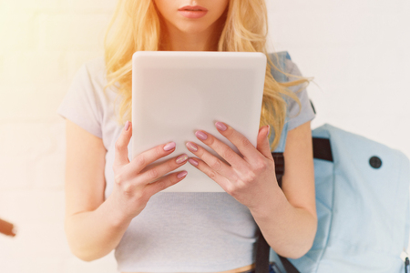 cropped shot of young student girl using tabletの写真素材