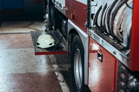 Close up view of protective helmet on fire truck at fire station