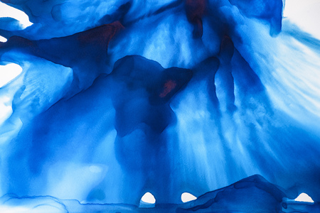 Blue splashes of alcohol ink as abstract backdropの写真素材