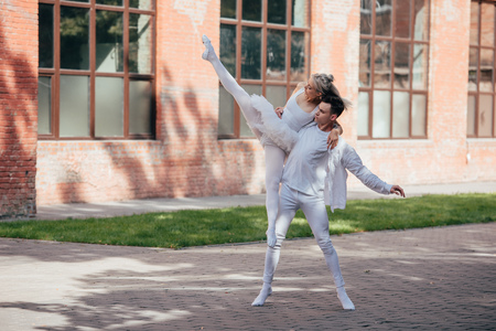Young dancers performing ballet on urban city streetの写真素材
