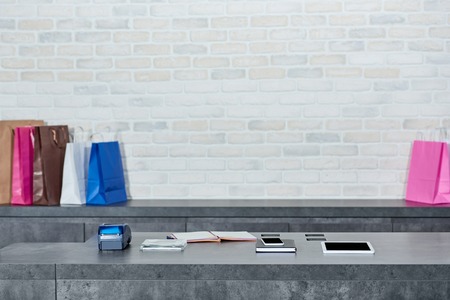 Digital devices, payment terminal and shopping bags in storeの写真素材