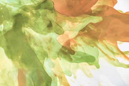 Beautiful brown and green splashes of alcohol inks as abstract backgroundの写真素材