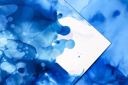 Blue splashes of alcohol ink on white as abstract backgroundの写真素材