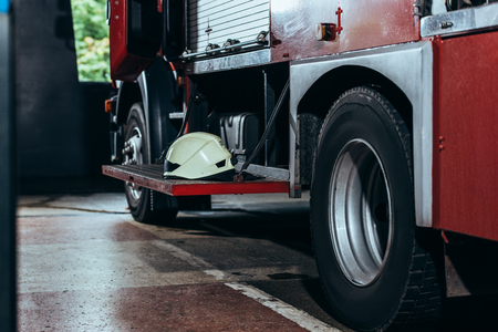 Close up view of protective helmet on fire truck at fire stationの写真素材
