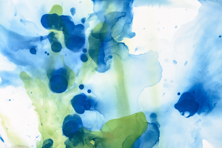 Green and blue splashes of alcohol inks as abstract backgroundの写真素材