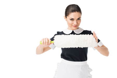 Professional maid in uniform holding duster isolated on white backgroundの写真素材