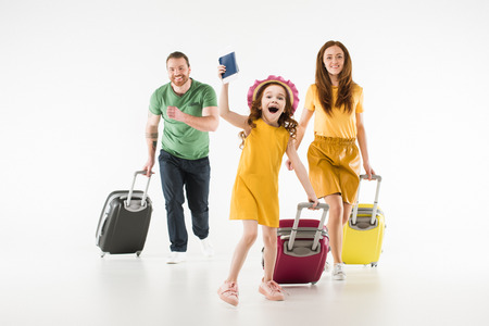 Happy running family with suitcases isolated on white background, travel conceptの写真素材