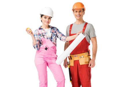 Male and female builders holding blueprint and ruler isolated on white background