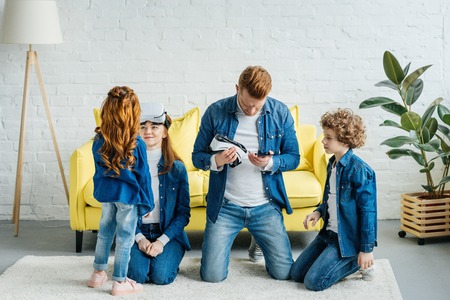 Happy family with kids discovering virtual reality technologyの写真素材