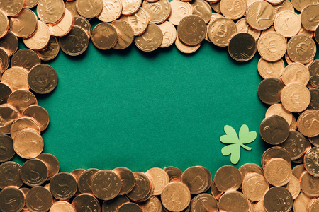 Top view of golden coins and shamrock on green table background, St Patrick's day conceptの写真素材