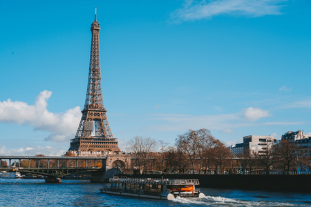 View on Eiffel Tower and boat on river in Paris, France