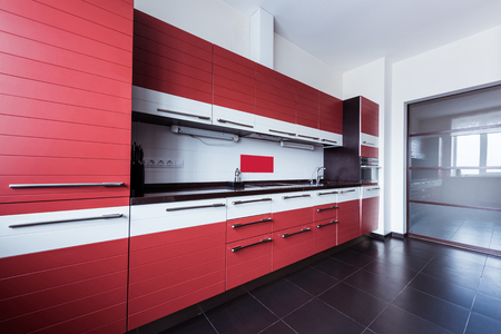 View of empty modern kitchen in red colorの写真素材