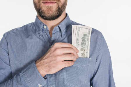 Partial view of bearded man with dollar banknotes in pocket isolated on white backgroundの写真素材