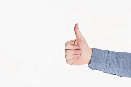 Cropped shot of man showing thumb up gesture isolated n white background