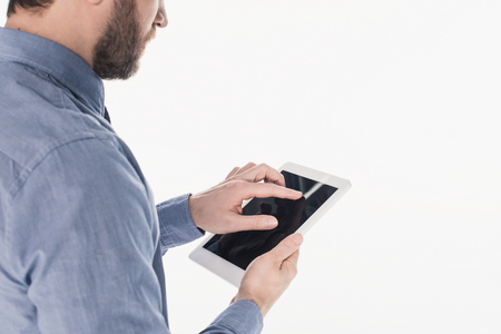 partial view of bearded man using tablet with blank screen isolated on whiteの写真素材