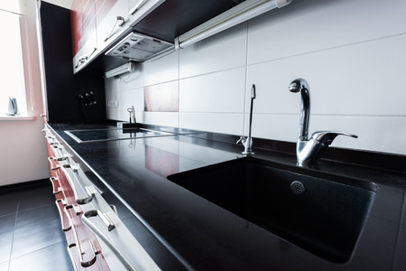 Close up view of sink and faucets in kitchenの写真素材