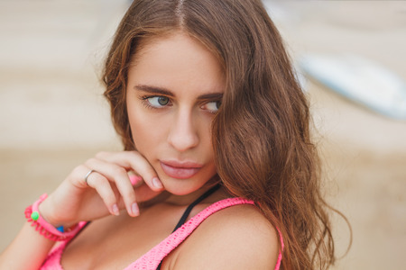 Attractive tender young woman posing on beachの写真素材