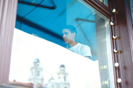 Through glass view of attractive African American man