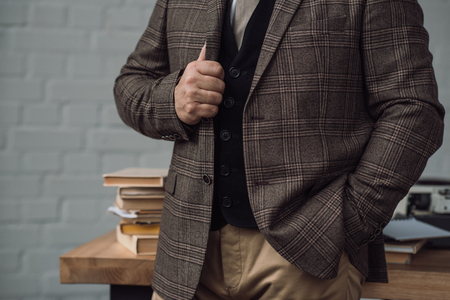 Cropped shot of senior writer in stylish tweed suit near workplaceの写真素材