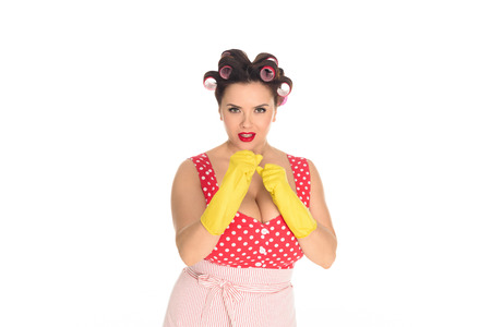 Angry plus size housewife in rubber gloves standing in fight pose isolated on white backgroundの写真素材
