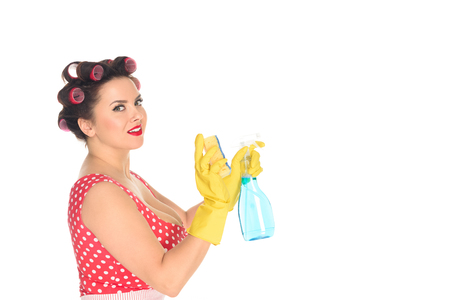 side view of plus size woman in rubber gloves with cleaning supplies isolated on whiteの写真素材