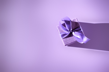 Top view of gift box with purple bow, ultra violet trendの写真素材