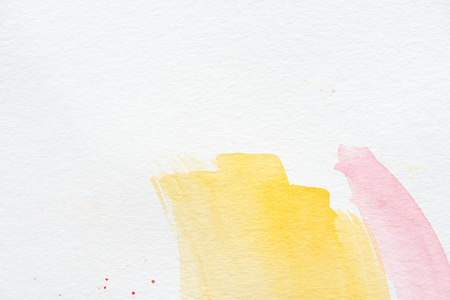 Abstract background with yellow and pink watercolor strokesの写真素材