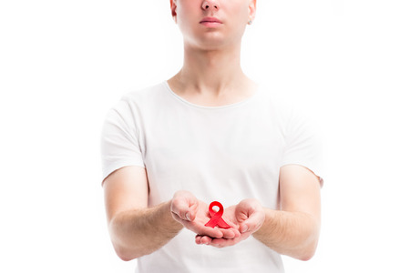 cropped image of man holding red ribbon isolated on white, world aids day concept