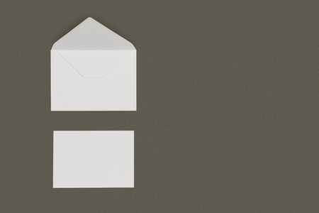 top view of open white envelope and blank card isolated on grey backgroundの写真素材