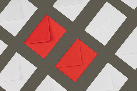 closed red and white envelopes isolated on grey backgroundの写真素材