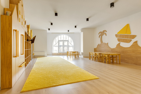 cozy light classroom with wooden furniture in modern kindergartenの写真素材