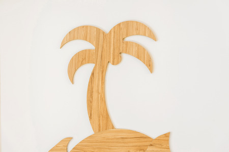 close-up view of decorative handmade wooden palm tree isolated on whiteの写真素材