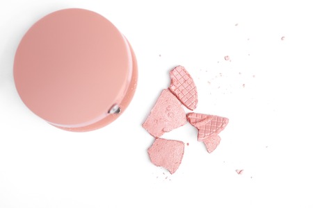 top view of cracked pink blush and container isolated on whiteの写真素材