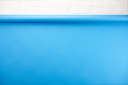 Bright blue background and white brick wall