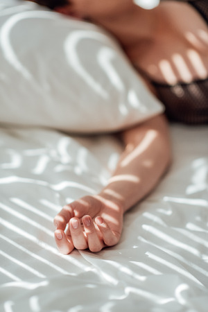 Partial view of woman sleeping in bedの写真素材