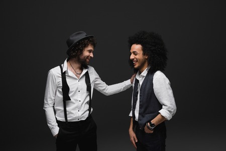 stylsih laughing men in white shirts on blackの写真素材