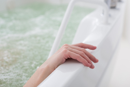 partial view of woman taking hydro bath in spa salonの写真素材