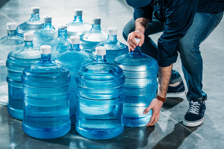 Man delivering large bottles with drinking waterの写真素材