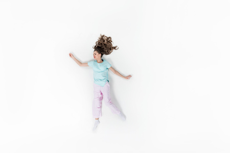 top view of young woman in pajamas sleeping isolated on whiteの写真素材