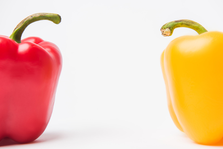 red and yellow bell peppers, on white backgroundの写真素材