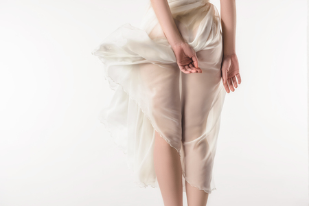 back view of nude girl in waving chiffon dress, isolated on whiteの写真素材